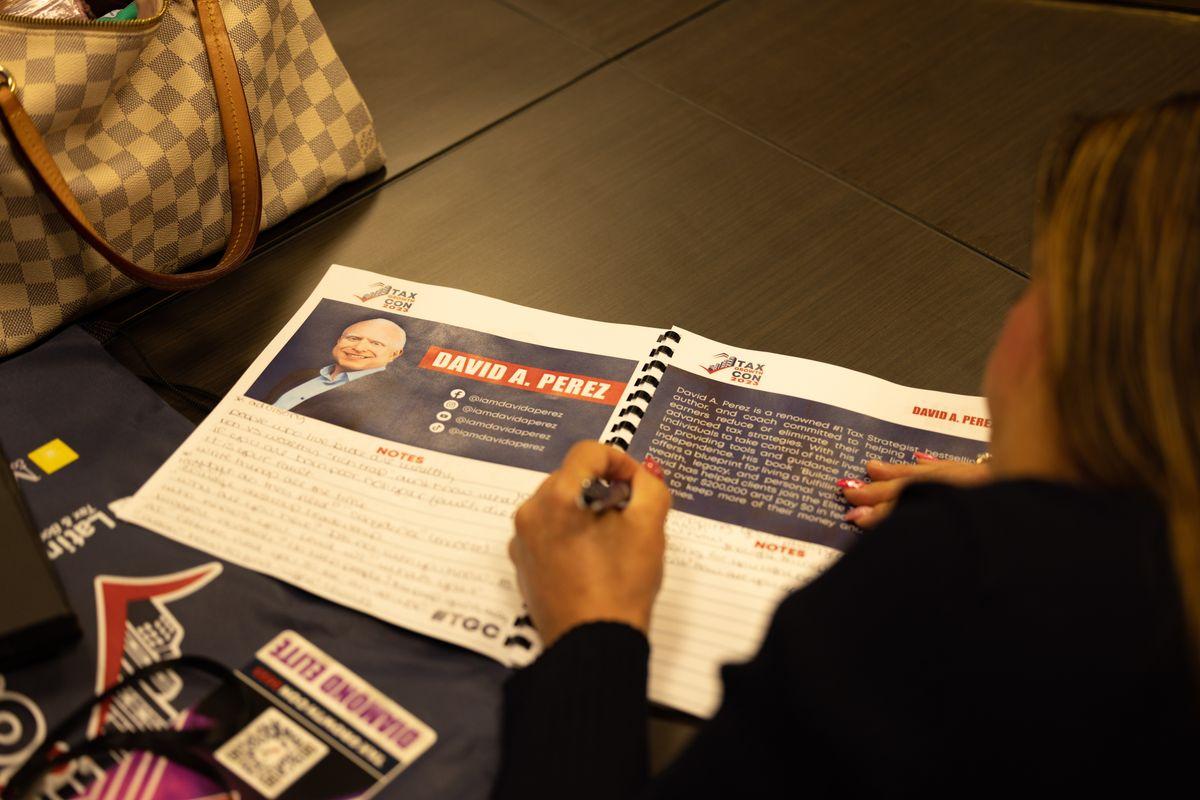 Attendee writing in the Maverick Flight Plan Workbook